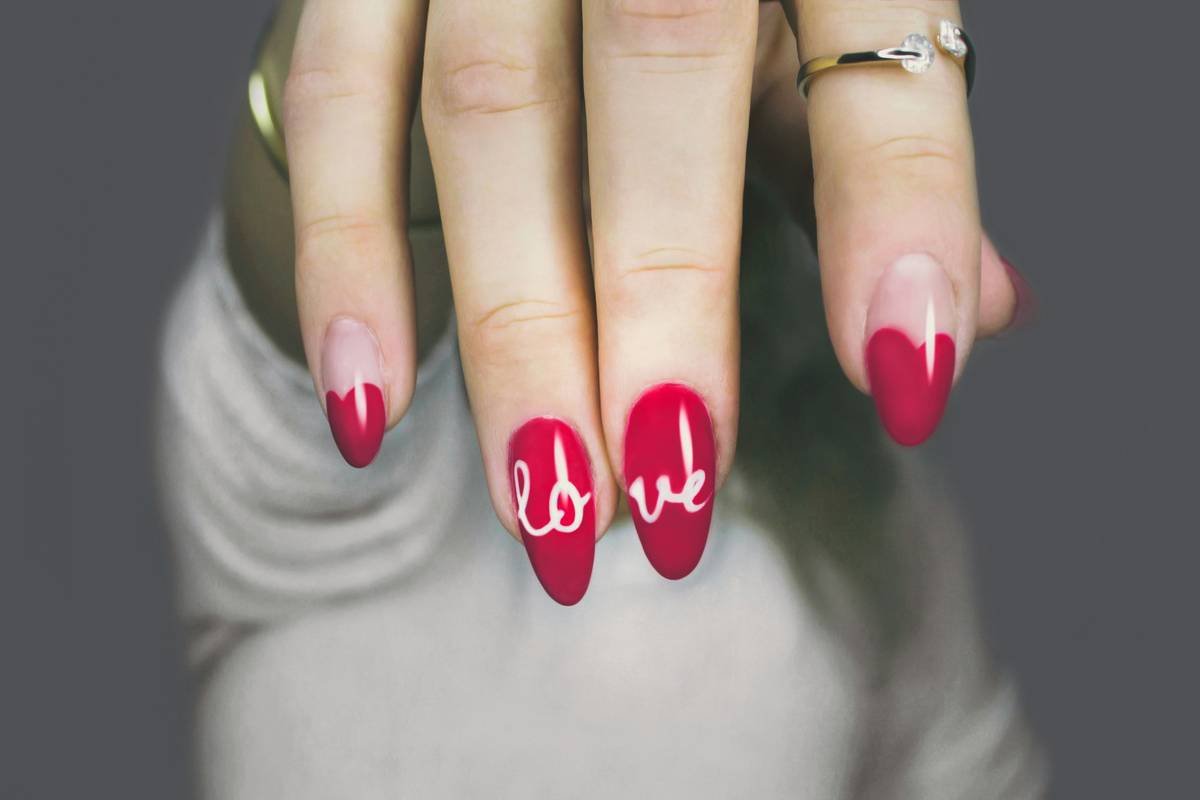 Side-by-side photo showing shaky hand using traditional brush vs. steady line from nail polish pen